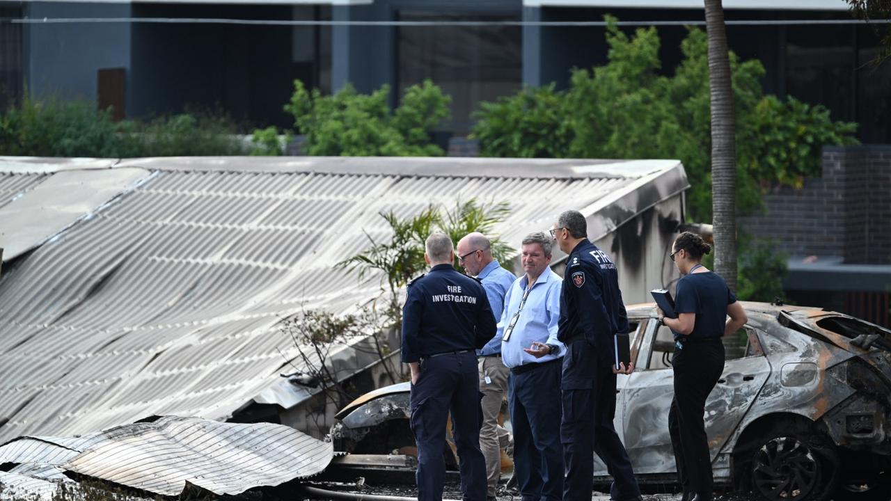 Police and fire investigators picture at the scene of the Woolloongabba fire. Picture: Lyndon Mechielsen