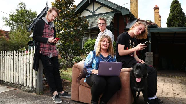 Yvonne Wallbank with her sons Max, Alex and Nic and dog Phoenix at their house in Cremorne, Sydney. She's not happy with her NBN connection. Picture: John Feder/The Australian