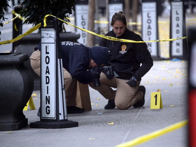 Police place bullet casing markers outside of a Hilton Hotel in midtown Manhattan where United Healthcare CEO Brian Thompson was fatally shot on December 4. Picture: Spencer Platt/Getty Images/AFP