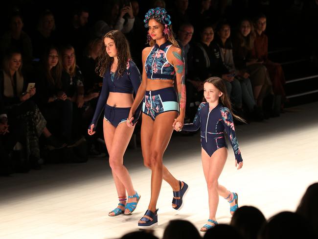 Samantha Harris walks down the catwalk with two young girls wearing creations from Duskii during the Mercedes-Benz Fashion Week Australia in Sydney, Wednesday, May 17, 2017. Picture: AAP