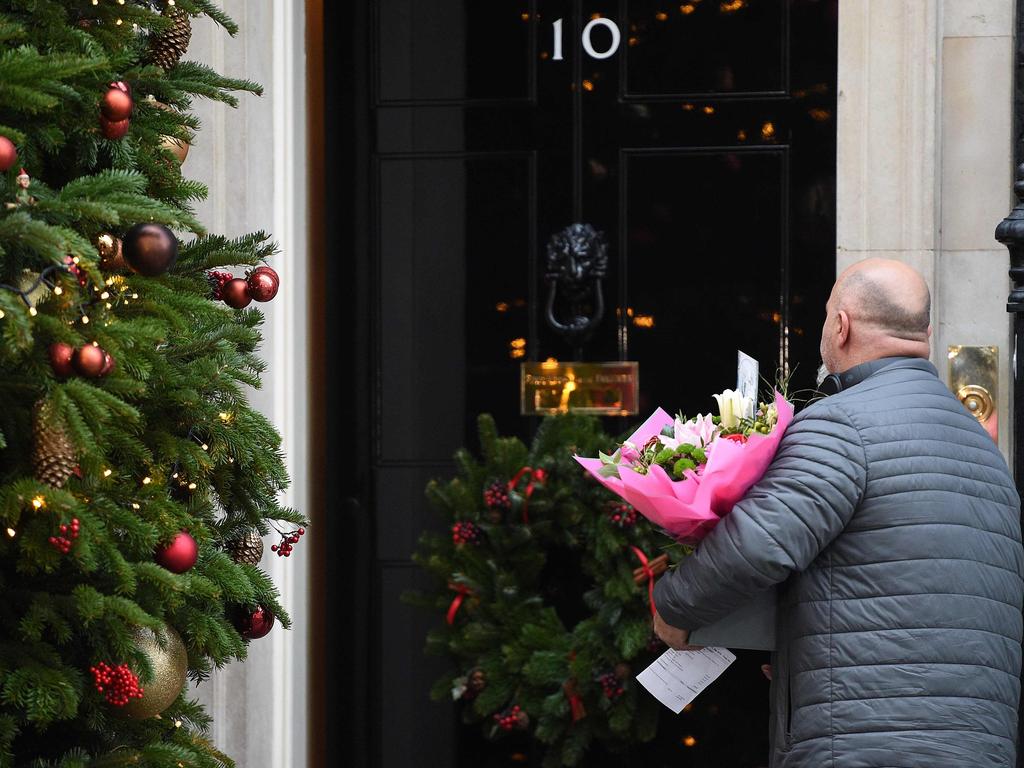 A man delivers flowers addressed to Britain's Prime Minister Theresa May, at 10 Downing Street in central London. Picture: AFP