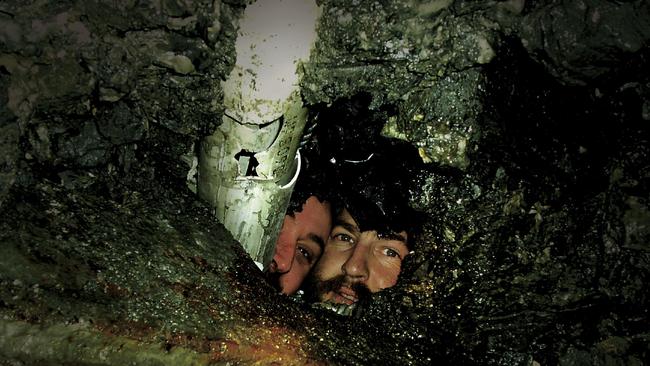 Miners Todd Russell and Brant Webb wearing the first warm, dry clothes sent to them down the PVC tube, while they are trapped underground in the Beaconsfield gold mine. Picture: Supplied by Brant Webb and Todd Russell, from the book 'Bad Ground: Inside The Beaconsfield Mine Rescue' by Tony Wright.