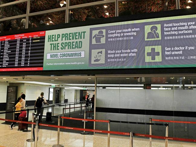 Warning signs about the coronavirus at Brisbane domestic airport. Picture: AAP