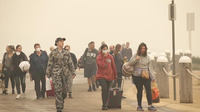 First of the evacuees walk down the road to Bastion Point Pier to be loaded on to ships. Picture: David Caird