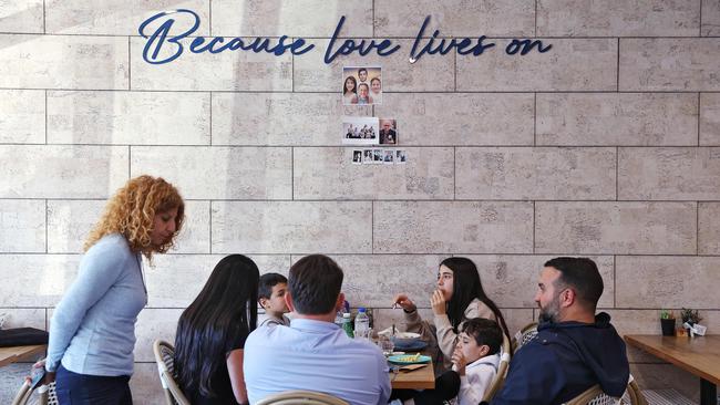 Bridget Sakr, (left) has lunch with Danny and Leila Abdallah at Quatre. The ‘love lives on’ wall and photos is pictured above. Picture: Sam Ruttyn