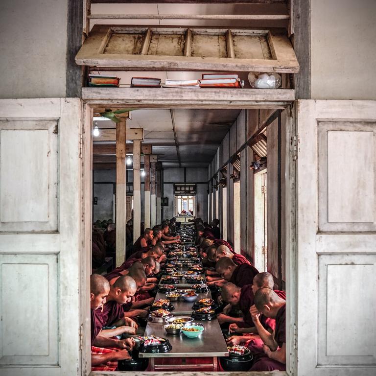 Sacred Monk Meal. Photographer : Matheus Hobold Sovernigo Year: 2018 “I was visiting Mahagandayon Monastery at Amarapura (Myanmar) to observe the monastic life. At noon, monks, nuns and novices lined up outside for their main and last meal of the day. Then, they went together to sit in the dining hall and eat. That’s when I stood in front of the side window and took this photo.” Copyright: © Matheus Hobold Sovernigo, Brazil, Entry, Open, Culture, 2018 Sony World Photography Awards