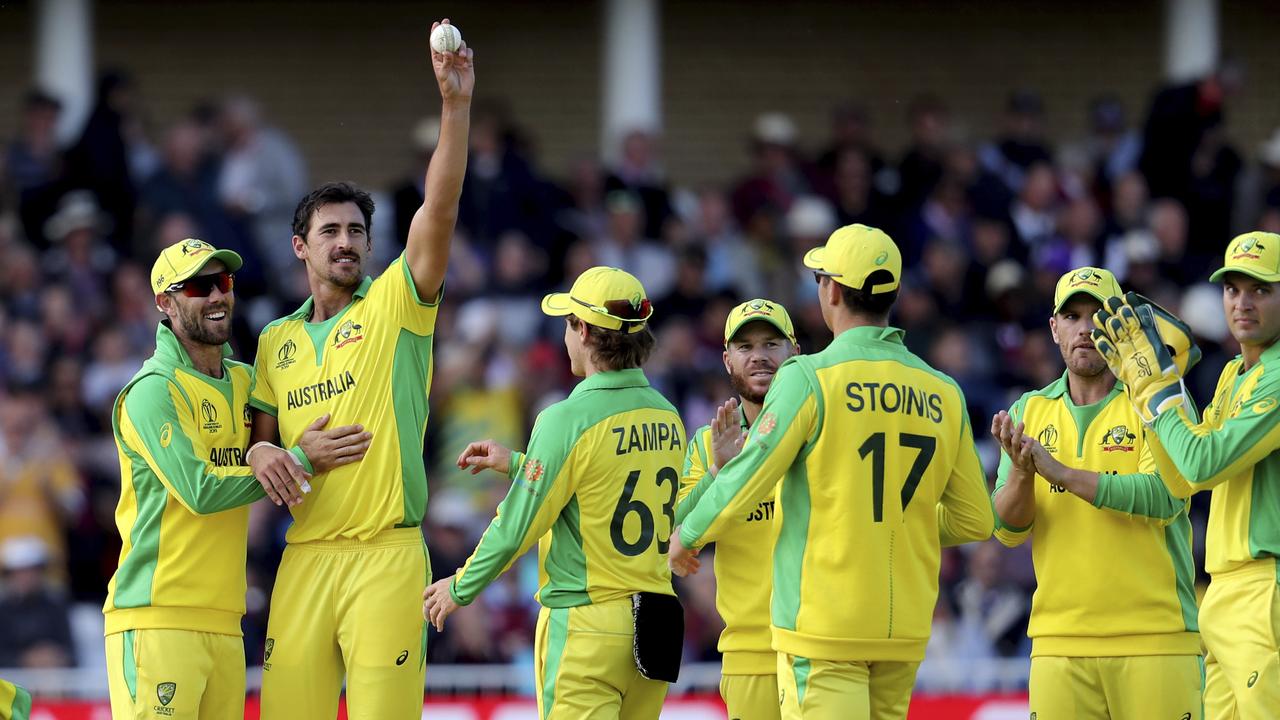 Australia's Mitchell Starc, second left, raises the ball after claiming yet another five-wicket haul.