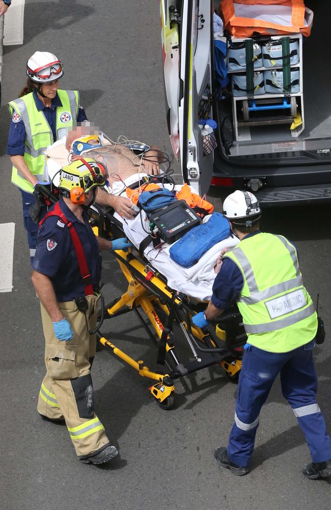An injured worker is taken to hospital at a building site in North Ryde where there has been a scaffolding collapse. Picture: Richard Dobson
