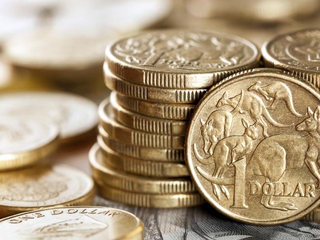 Stacks of Australian one dollar coins. Focus on front coin.