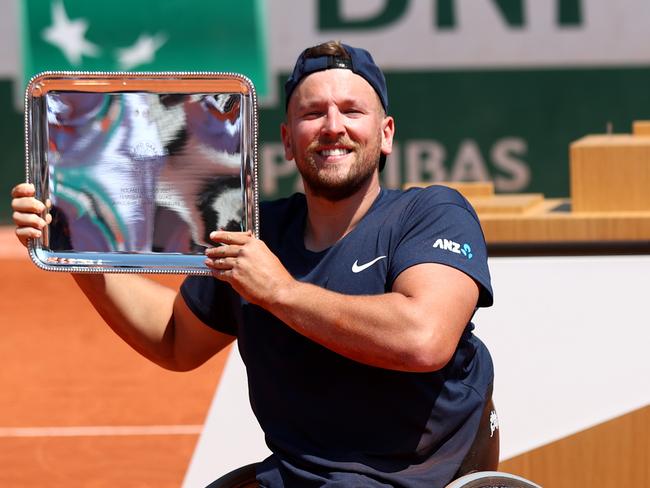 PARIS, FRANCE - JUNE 07: Dylan Alcott of Australia lifts the winners trophy following victory in their quad wheelchair mens singles final against Sam Schroder of The Netherlands during day nine of the 2021 French Open at Roland Garros on June 07, 2021 in Paris, France. (Photo by Julian Finney/Getty Images)