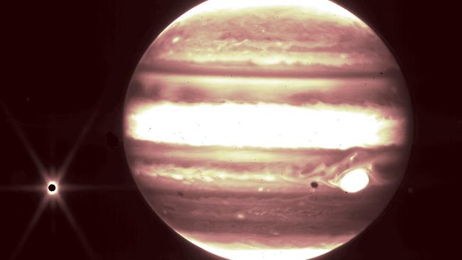 This handout image released by NASA on September 21, 2023, shows the planet Jupiter (R) and it's moon Europa (L) as seen through The James Webb Space Telescope NIRCam instrument 2.12 micron filter. (Photo by B. HOLLER and J.STANSBERRY / ESA, NASA, CSA, STScI / AFP)