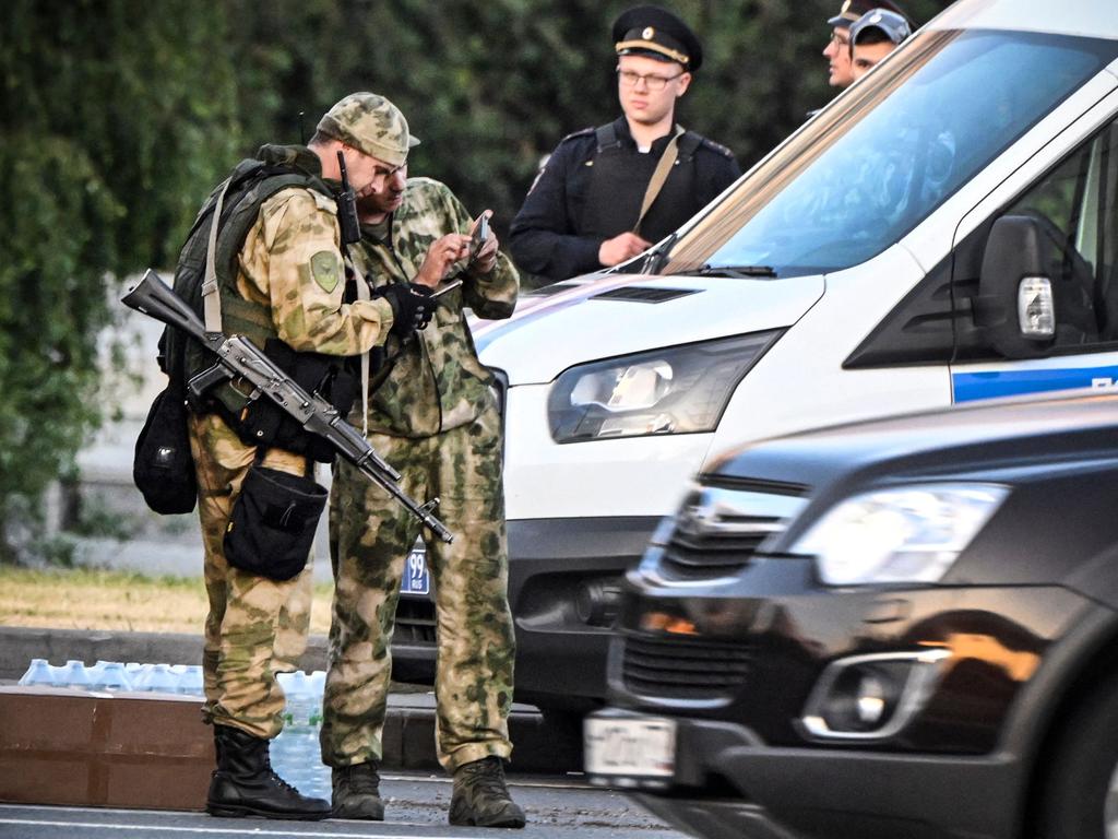 Russian soldiers and police officers stand an the edge of one of the highways entering Moscow. Picture: AFP