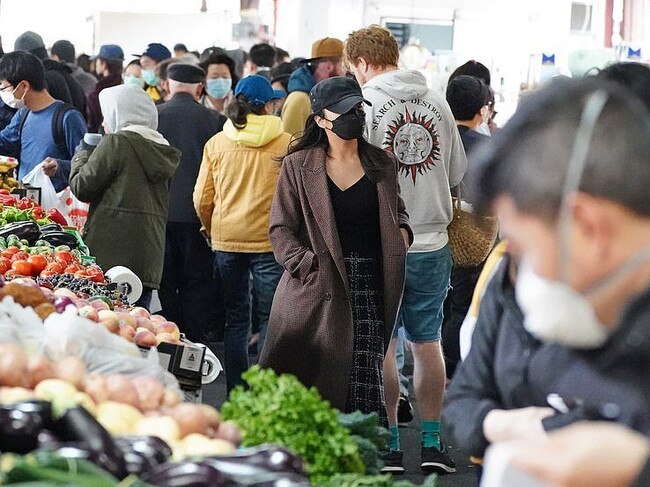 People at the Queen Victoria Market in Melbourne appear to be ignoring social distancing rules