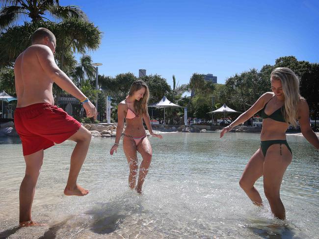 Felix Bogrem, Ida Kia and Mathilee Jaeger make the most of Brisbane’s Streets Beach at South Bank. Photo: Adam Armstrong.