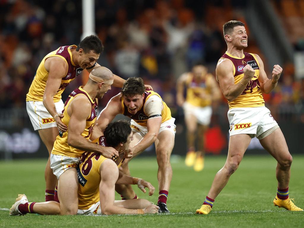 Dayne Zorko (right) and his Lions teammates are delighted after Brisbane’s five-point win over the GWS Giants. Picture: Phil Hillyard