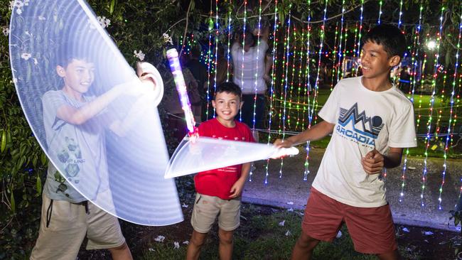 Brothers (from left) Cayden, Harry and Neoby Weber having fun with light toys at Toowoomba's Christmas Wonderland in Queens Park, Saturday, December 7, 2024. Picture: Kevin Farmer