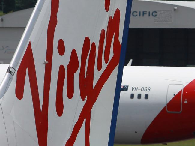 FILE- Virgin Australia and QANTAS tails at Cairns Airport.