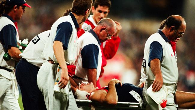 Shaun Smith is stretchered off during the 1997 Round 3 AFL match between the Melbourne Demons and the Sydney Swans.