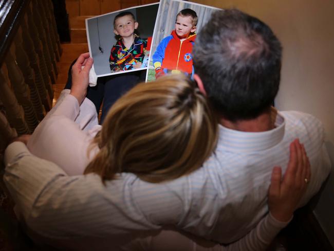 William Tyrrell's foster parents looking at pictures of their missing son in Sydney. 