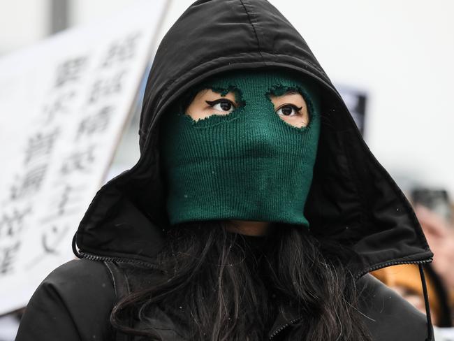 BERLIN, GERMANY - DECEMBER 03: A participant with a sky mask at a protest in front of the Chinese Embassy in solidarity with protesters in China on December 3, 2022 in Berlin, Germany. Protests have been occurring in cities across China recently over the country's ongoing intense Covid lockdowns. A common feature has included protesters holding up blank sheets of A4 paper to symbolize China's heavy-handed enforcement against free speech. (Photo by Omer Messinger/Getty Images)