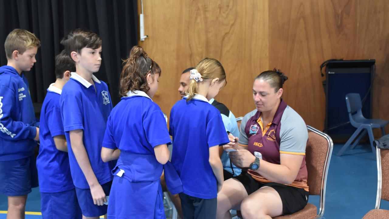 Students were eager to get the signatures of the two NRL superstars.