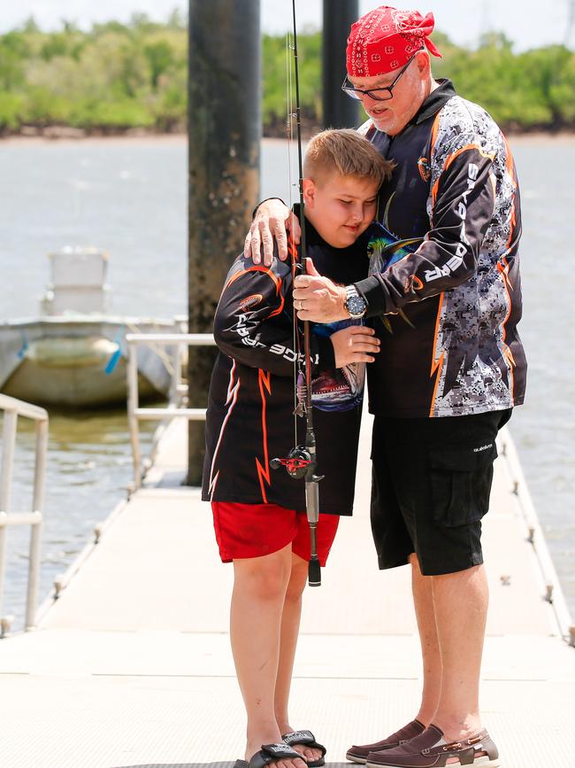 Peter Chandler holds son Harrison tight after their brush with death in the Elizabeth River. Picture: GLENN CAMPBELL