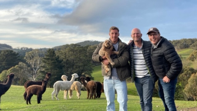 Rangeview owners Peter Egglestone, middle, and Andy Bousie, right, with their son Josh, cavoodle Digger and alpacas.