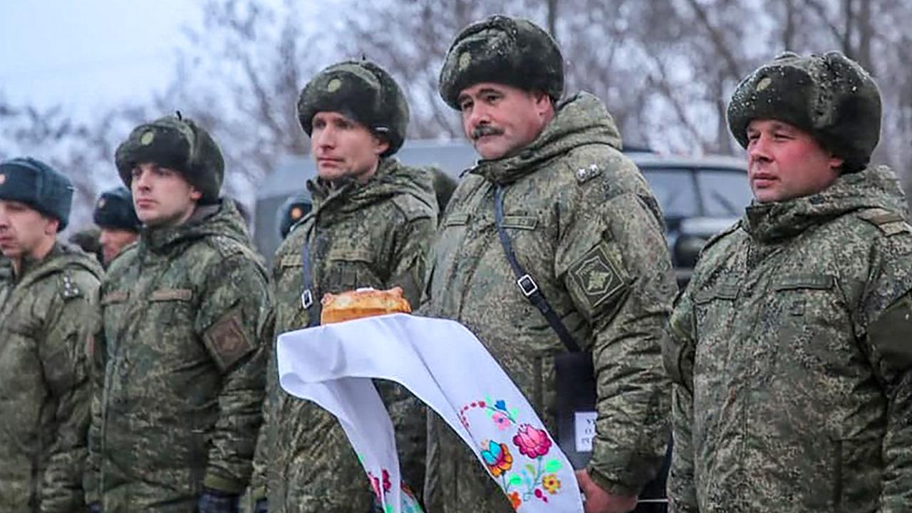 Russian servicemen holding a traditional Belarus’ bread and salt upon their arrival for the joint drills in Belarus. Picture: Belarus Ministry of Defence/AFP