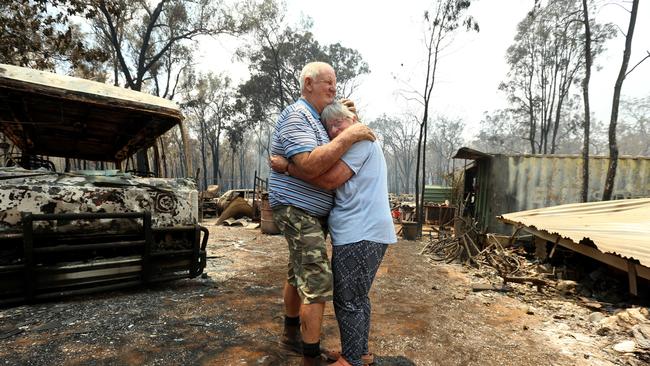 Laurie Campbell and his wife Lyn with what is left of their house destroyed by the bushfires. Picture: Nathan Edwards