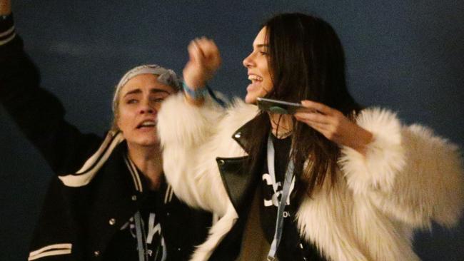 Kendall Jenner (right) and Cara Delevingne watching Kanye West performing on The Pyramid Stage at the Glastonbury Festival, at Worthy Farm in Somerset.. Picture date: Saturday June 27, 2015. Photo credit should read: Yui Mok/PA Wire