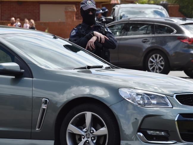 An officer looks on during the terror raid in Meadow Heights. Picture: Jay Town