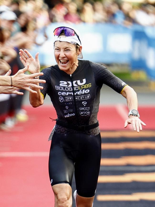 Kylie Simpson crosses the finish line on the Cairns Esplanade to win the Ironman Cairns Asia Pacific Championship race. Picture: Brendan Radke