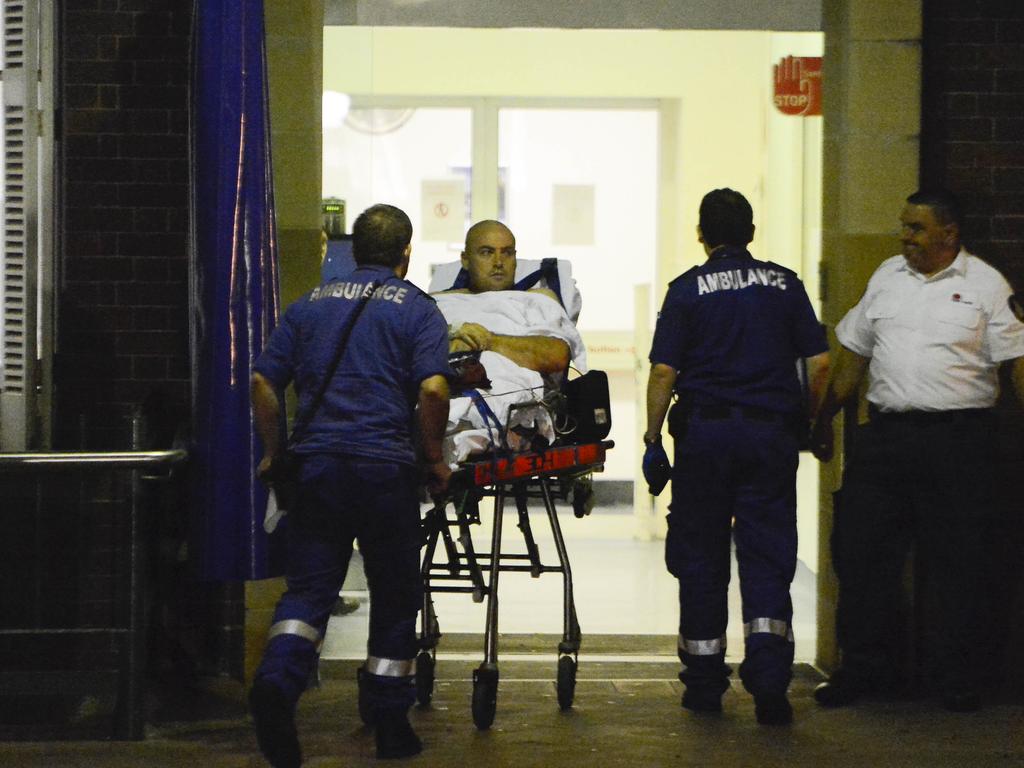 A wounded police officer is wheeled into the RPA hospital. He has since been discharged and has returned home. Photo: Chris McKeen