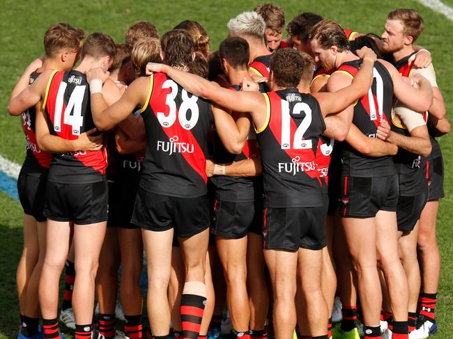 GOLD COAST, AUSTRALIA - SEPTEMBER 19: The Bombers huddle during the 2020 AFL Round 18 match between the Essendon Bombers and the Melbourne Demons at Metricon Stadium on September 19, 2020 in Gold Coast, Australia. (Photo by Michael Willson/AFL Photos via Getty Images)