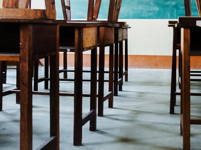 chair and table in class room with black board background, no student, school closed concept Picture: Istock