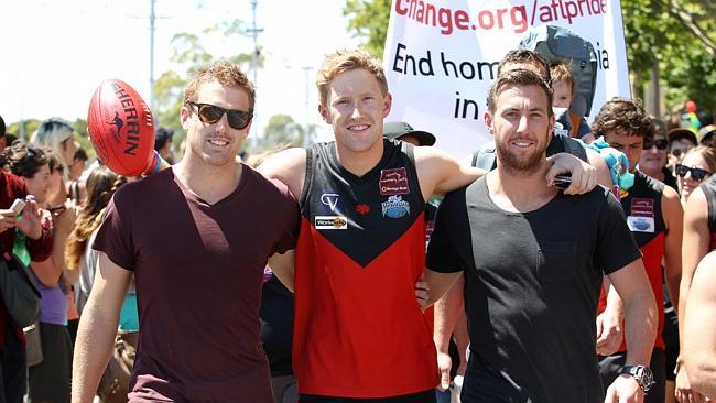 Richmond’s Daniel Jackson (left) and Carlton’s Brock McLean (right) join openly gay Yarra Glen footballer Jason Ball in a gay pride march. Picture: Andrew Tauber