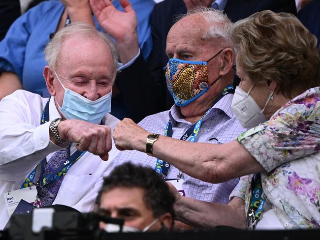 Rod Laver (left) and Neale Fraser (centre) at the women’s final. Picture: Quinn Rooney/Getty