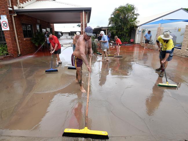 Friends and family help clean a flood affected motel in Townsville. Picture: Dan Peled