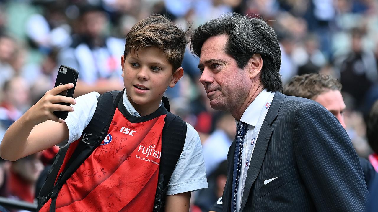 AFL CEO Gillon McLachlan poses for a photo with a fan. Picture: Quinn Rooney/Getty Images