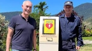 Former Wiggle Greg Page with Cairns Police Dog Squad Sergeant Dave Raymond and Police Dog Axel at the at the launch of Goldsborough’s first community Automated External Defibrillator (AED) on September 18, 2022.