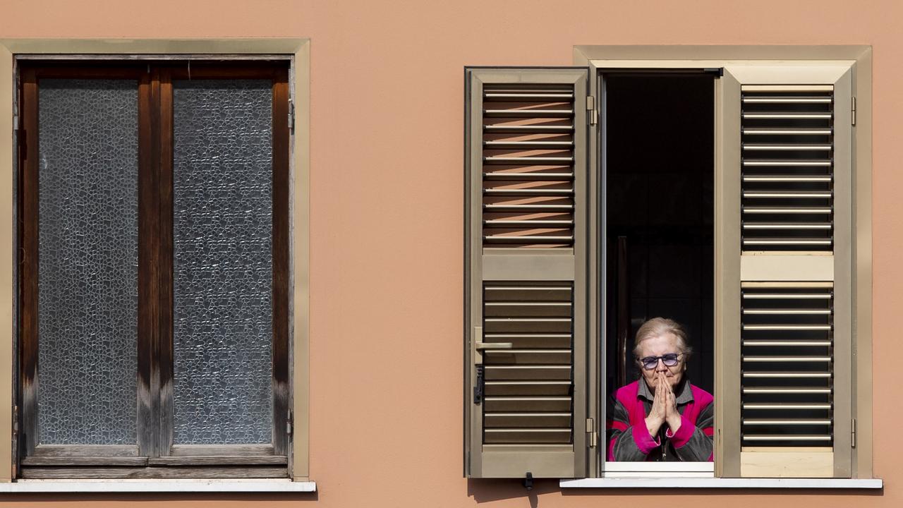 A woman in Italy prays amid the virus lockdown. Picture: Tiziana Fabi/AFP