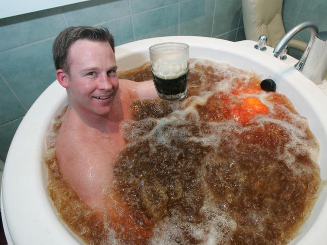 Liberal State Deputy Opposition Leader Will Hodgman enjoys a beer bath and a glass of beer at the Hobart Sanctuary day spa