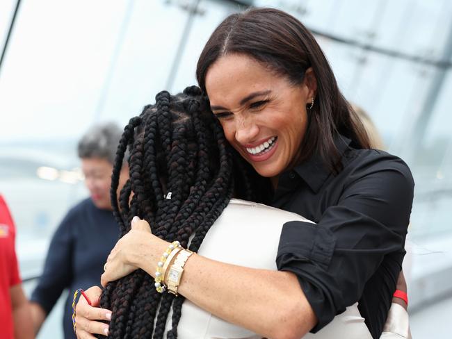 Meghan Markle hugs Glory Essien at the event. Picture: Getty Images