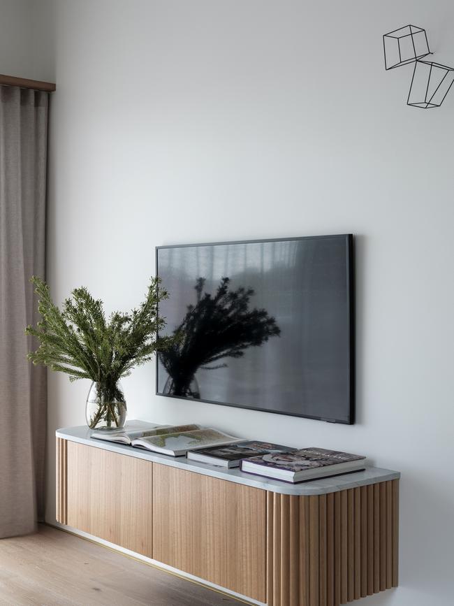 The clean new aesthetic was mirrored in the living area with a floating TV cabinet.