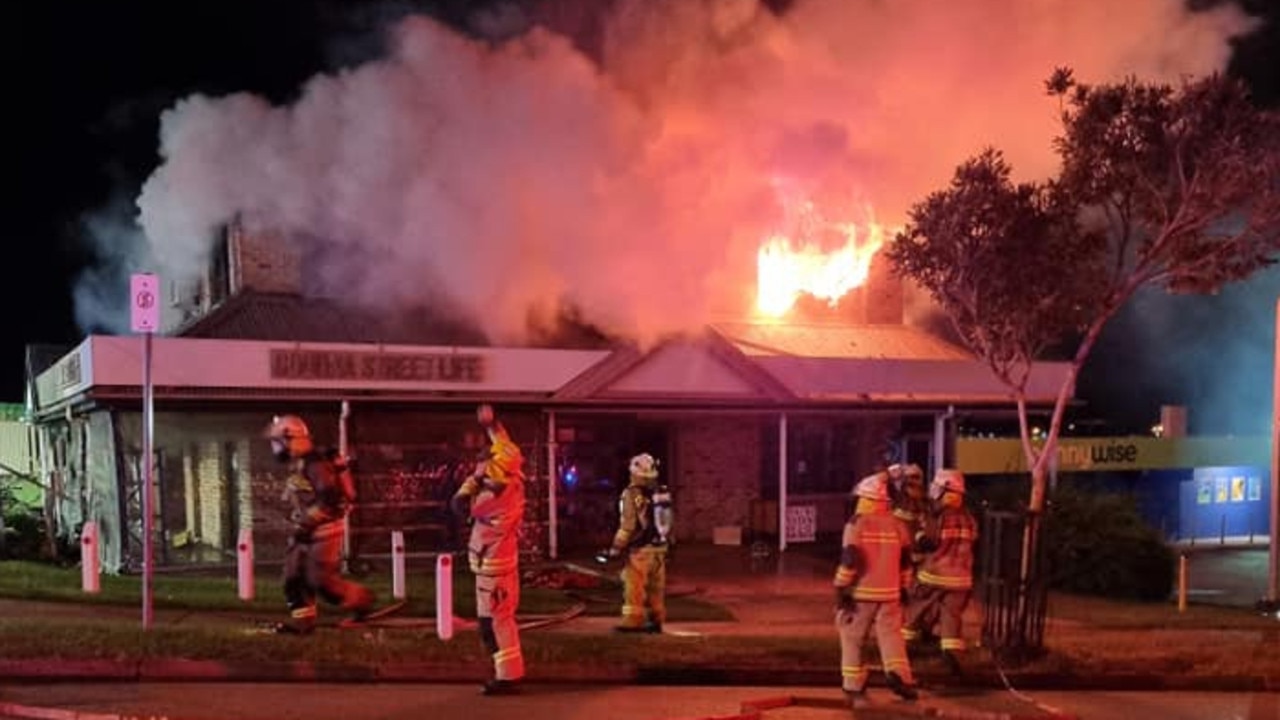 Firefighters battle a fire which destroyed the Goodna Street Life op shop on Tuesday morning.