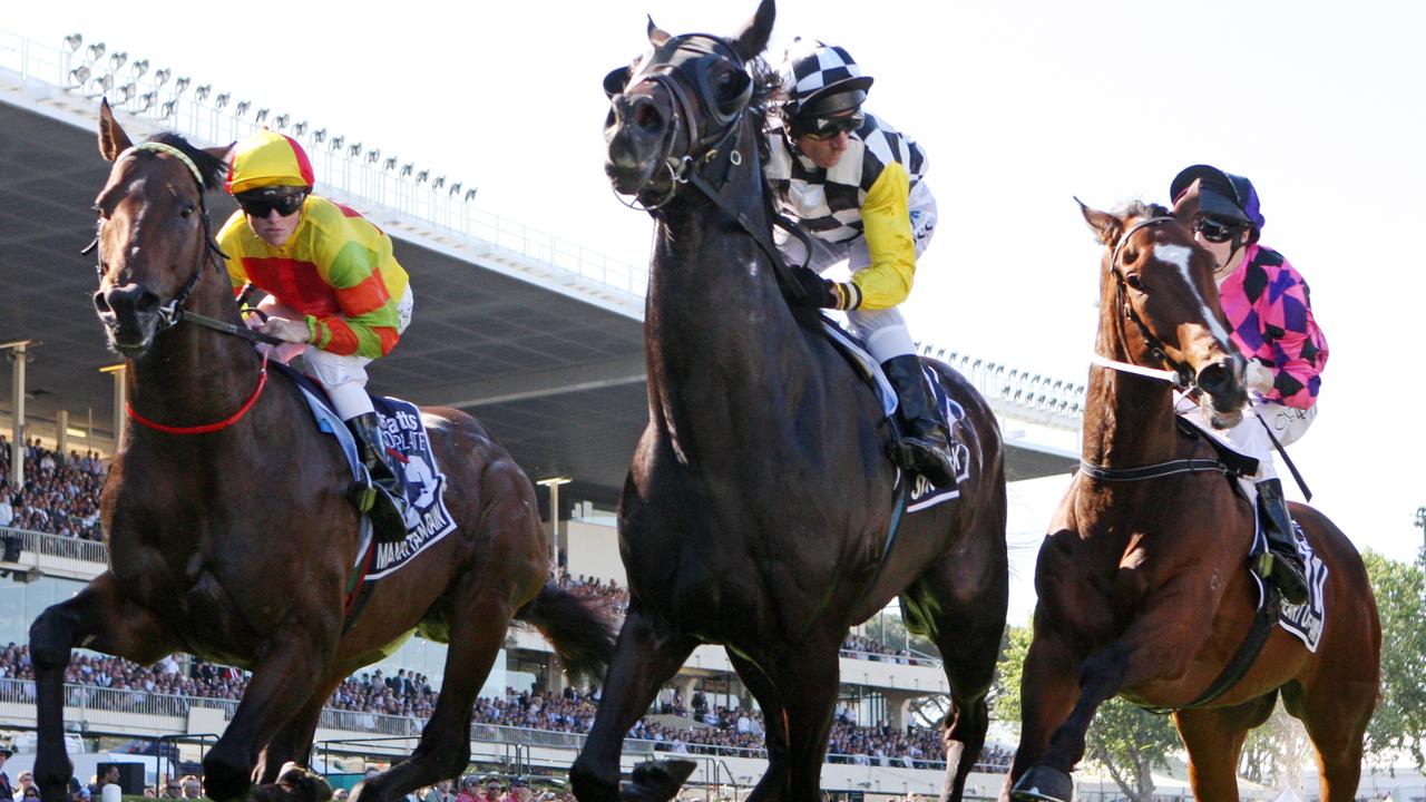 Glen Boss on So You Think (black and white check, yellow sleeves ) heads past the post for the first time, on his way to winning in the 2009 Cox Plate at Moonee Valley