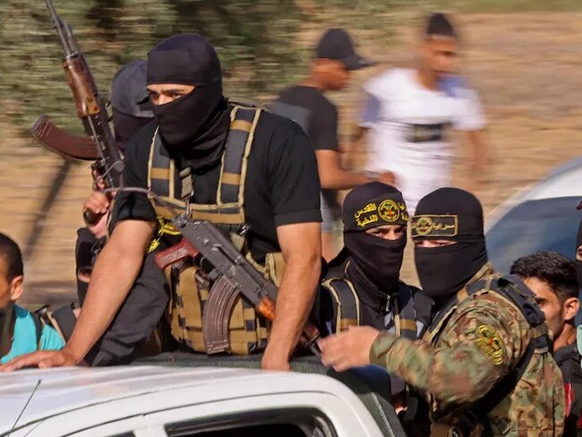 Hamas militants approach Israeli border on Oct. 7 (Credit: Said Khatib/AFP/Getty Images)