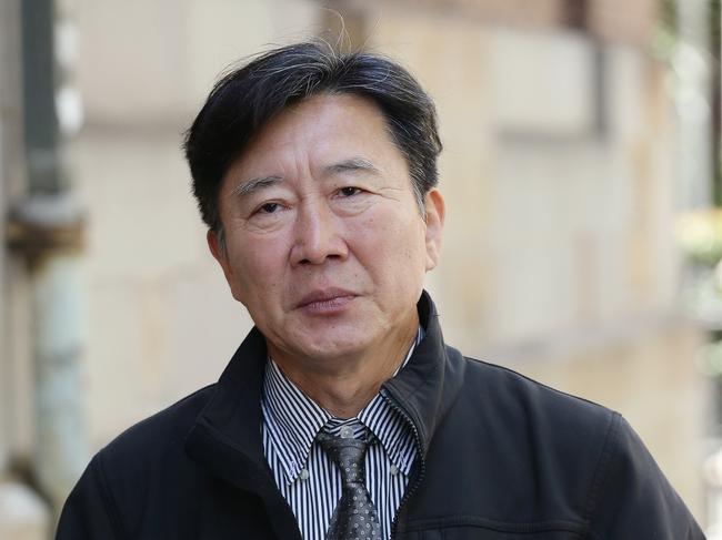 SYDNEY, AUSTRALIA - NewsWire Photos February 03 2021: Chan Han Choi walks from the Downing Centre Courts to the Supreme Court on King Street in Sydney today. The Australian man is accused of trying to broker missile deals for the North Korean regime. He was seen with several supporters. Picture: NCA NewsWire / David Swift