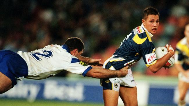 Scott Prince attempts to get past a lunging Bulldog during a game for the Cowboys in 2000. Picture: Scott Radford-Chisholm