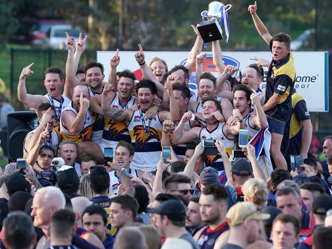 Darryl Thomas (front left) and his teammates celebrate last year’s premiership.